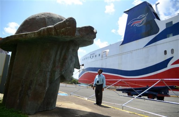 Tony Jacobs, director of the port of Mayaguez, looks at the head of a statue of Christopher Columbus, one of many pieces strewn across the port storage area in Mayaguez, Puerto Rico, on Sept. 2. The Columbus statue would be the tallest structure in the Caribbean and among the tallest statues in the world.